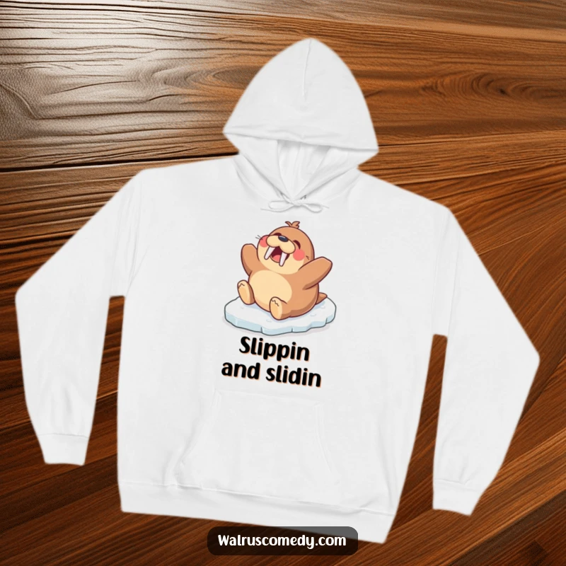 Funny hoodie depicting a happy walrus character gleefully sliding down an icy slope on its tummy, capturing pure winter fun.