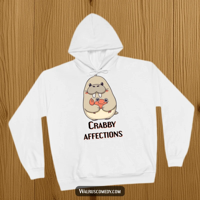 Funny hoodie showing a surprised walrus being embraced by a small, affectionate crab.