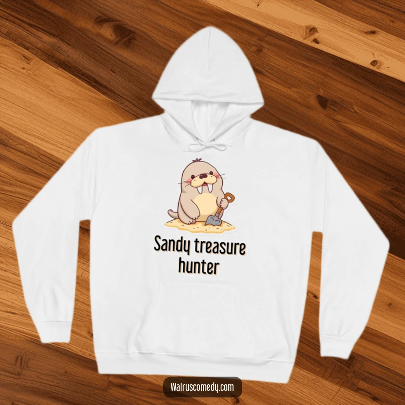 Funny Hoodie: A cheerful walrus character energetically digs in the sand using a miniature shovel, radiating beach joy.