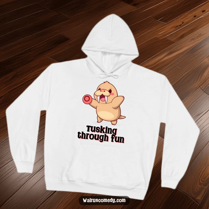 Funny cozy hoodie showcasing a kawaii walrus with tusks, happily throwing a frisbee, radiating warmth and playful energy.